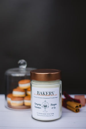 Bakery candle with macaroons and cinnamon sticks